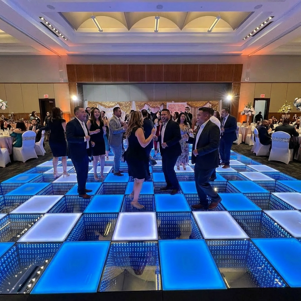 Guests dancing on a blue LED Dance Floor at an indoor event with elegant décor and a lively celebration atmosphere.