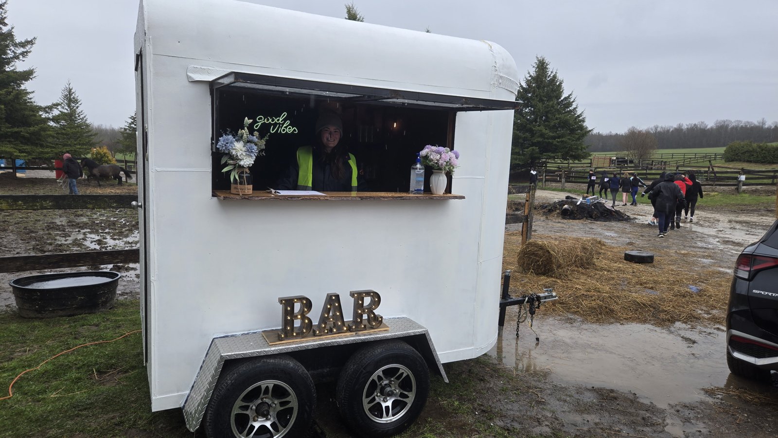 Guests enjoying Travelling Spirits Mobile Bar under string lights